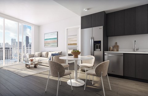 a living room with a table and chairs and a kitchen